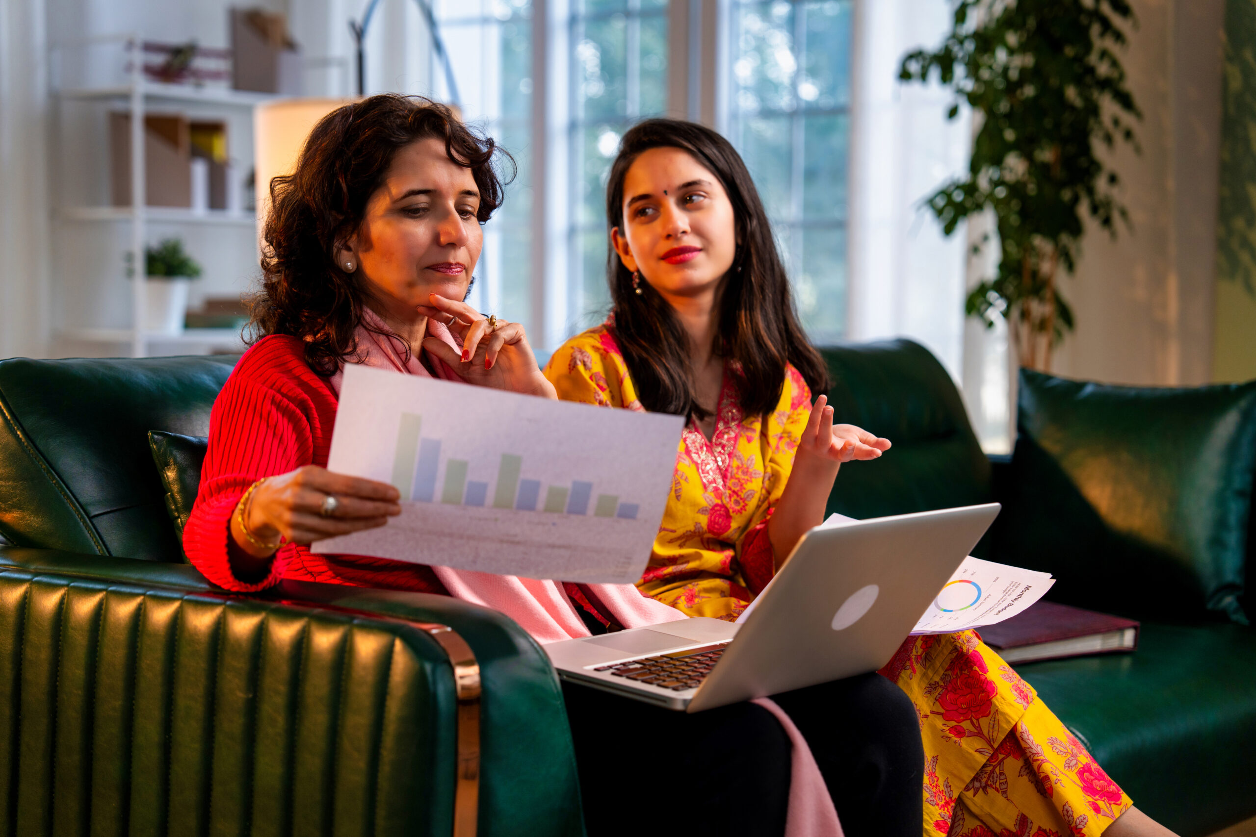 Two Ladies in office discussing Budget in a cow working space